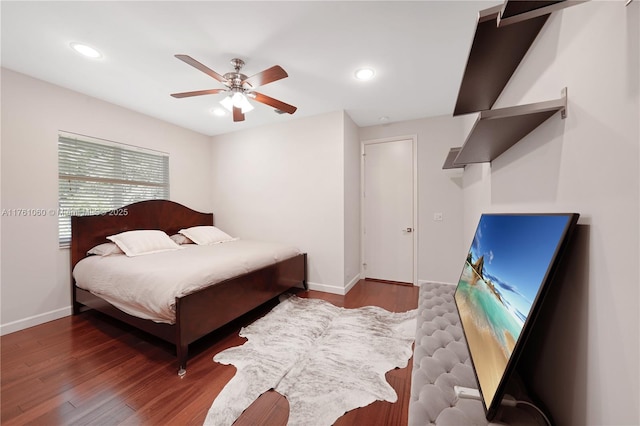 bedroom featuring a ceiling fan, recessed lighting, wood finished floors, and baseboards