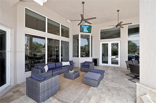 view of patio with a ceiling fan, an outdoor living space, and french doors