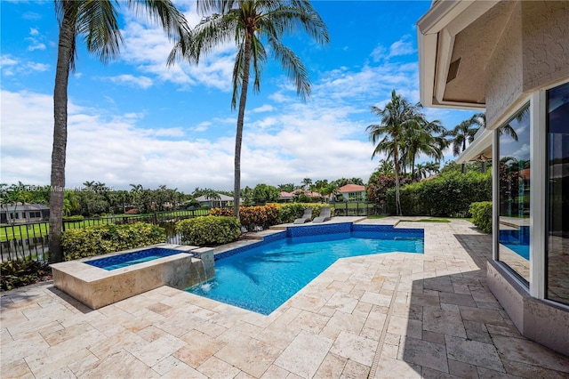 view of pool featuring a patio, a fenced backyard, and a pool with connected hot tub