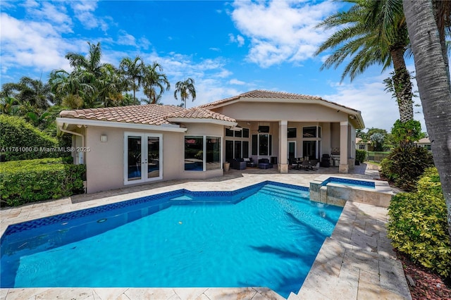 view of pool with a patio, fence, a pool with connected hot tub, french doors, and outdoor lounge area