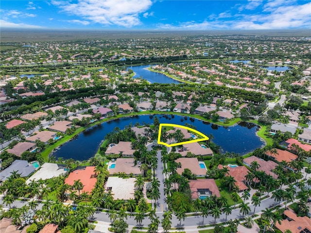 birds eye view of property with a water view and a residential view