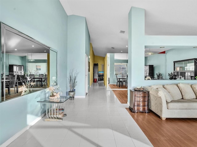 living room featuring visible vents, baseboards, and wood finished floors