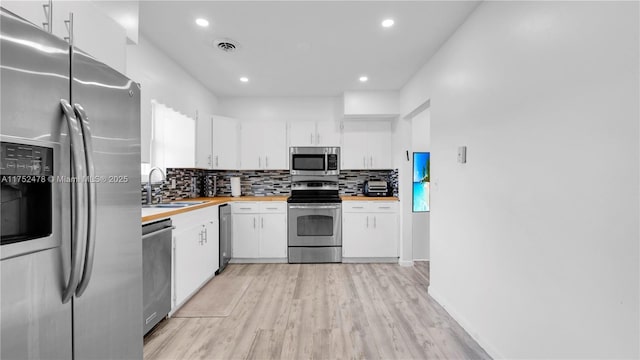 3349 W Park Rd, Hollywood, FL 33021 - kitchen with visible vents, wooden counters, white cabinets, stainless steel appliances, and a sink