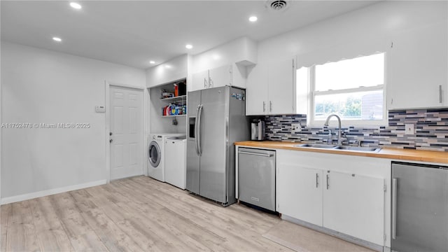 3349 W Park Rd, Hollywood, FL 33021 - kitchen with visible vents, wooden counters, a sink, stainless steel appliances, and independent washer and dryer