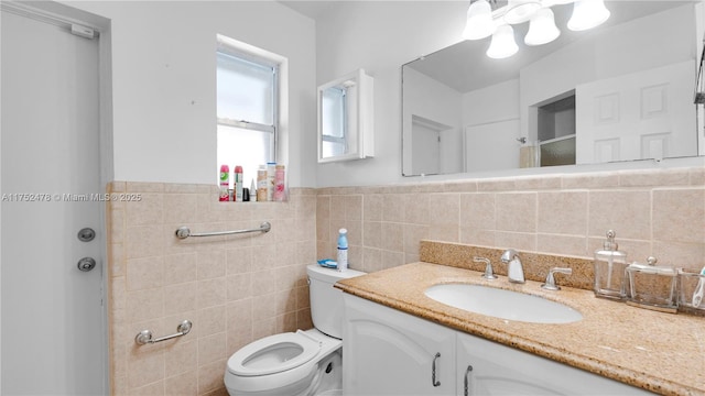 3349 W Park Rd, Hollywood, FL 33021 - bathroom with vanity, tile walls, toilet, and wainscoting
