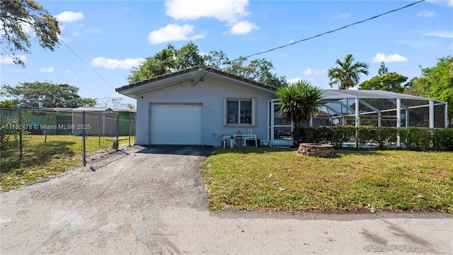 3349 W Park Rd, Hollywood, FL 33021 - view of front of house featuring stucco siding, aphalt driveway, fence, glass enclosure, and an attached garage