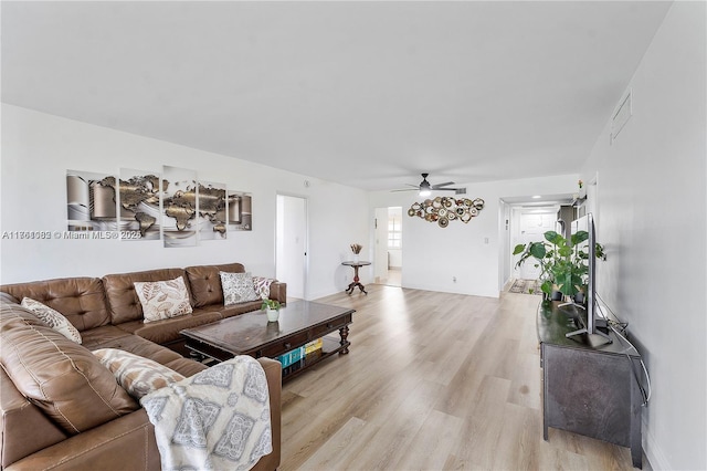 living area featuring visible vents, a ceiling fan, and light wood-style floors