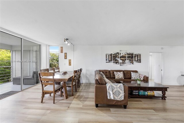 bedroom with light wood-type flooring, baseboards, and a ceiling fan