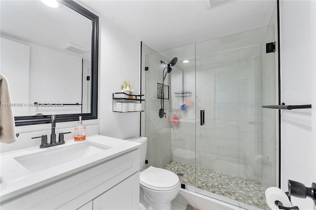 bathroom with vanity, toilet, and a shower stall