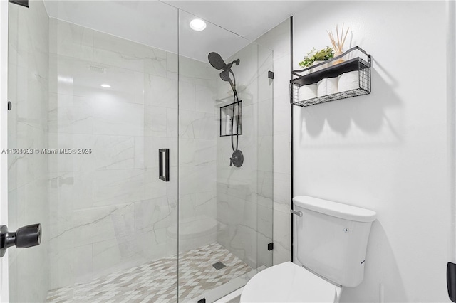 full bathroom with a shower stall and toilet