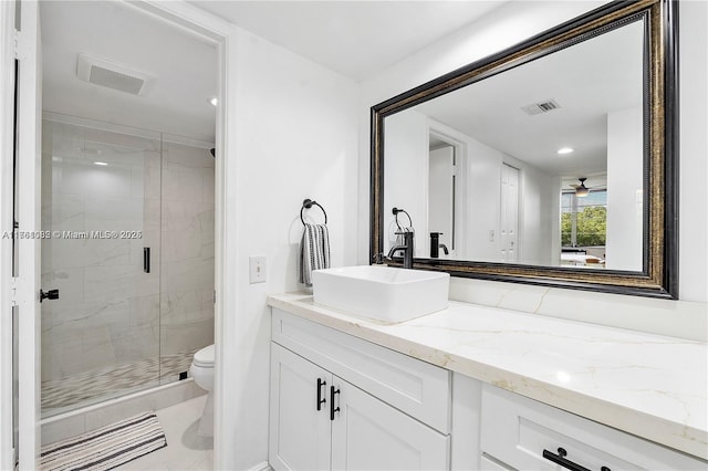 full bath featuring a marble finish shower, visible vents, toilet, and vanity