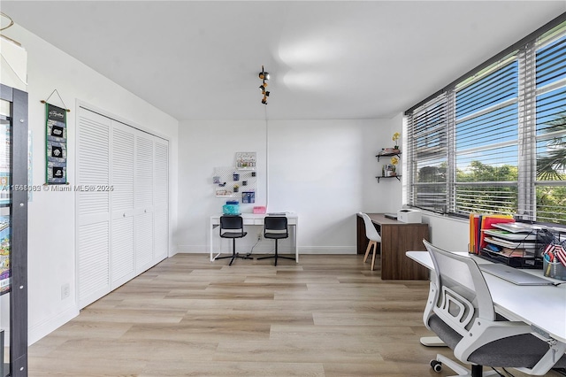 office area featuring baseboards and wood finished floors