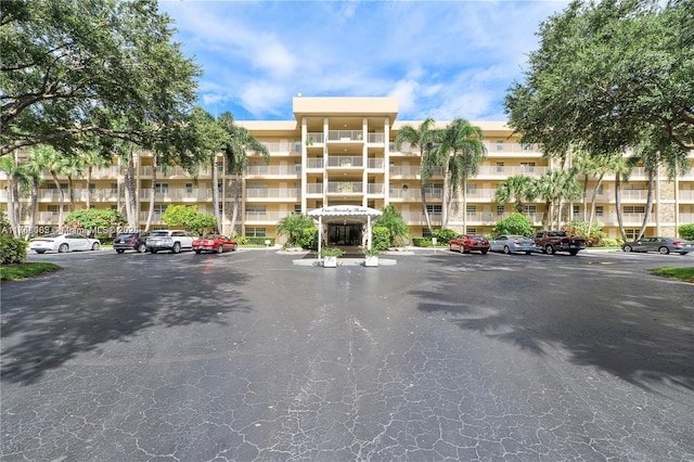 view of building exterior featuring uncovered parking