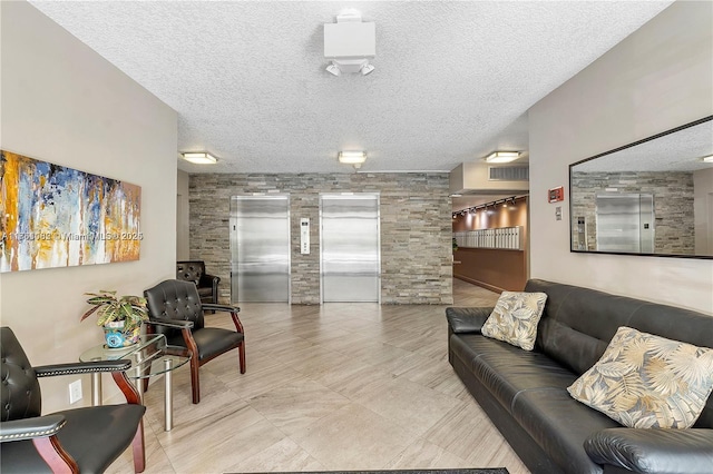 interior space featuring elevator and a textured ceiling