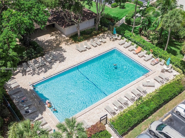 community pool featuring a patio area and fence