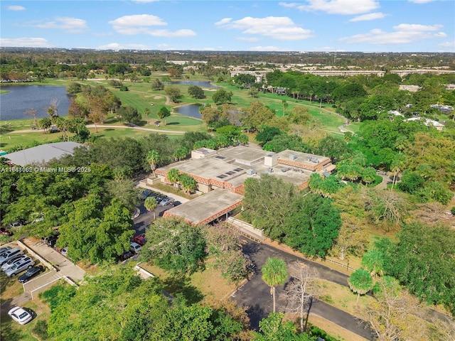 drone / aerial view featuring view of golf course and a water view