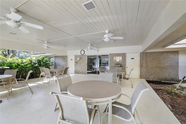 view of patio with outdoor dining space and visible vents