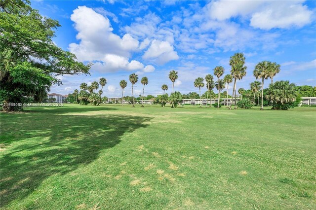 view of community featuring a lawn and golf course view
