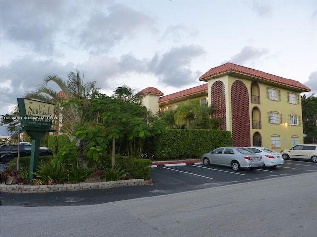 view of property featuring uncovered parking