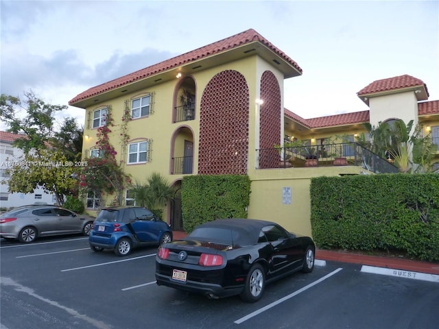 view of building exterior featuring uncovered parking