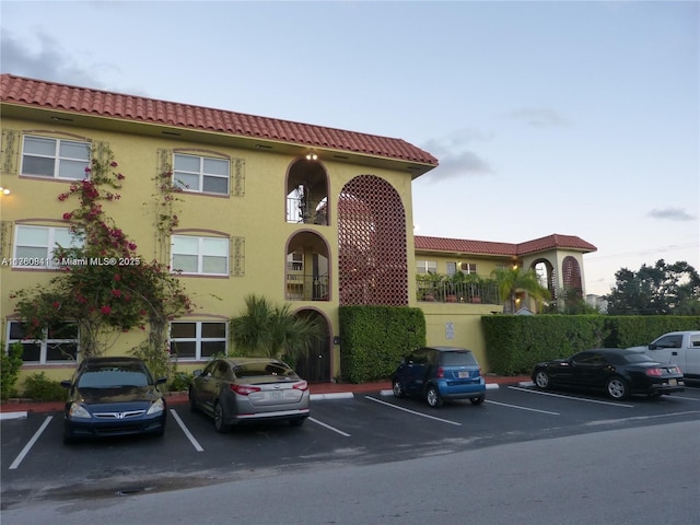 view of building exterior with uncovered parking