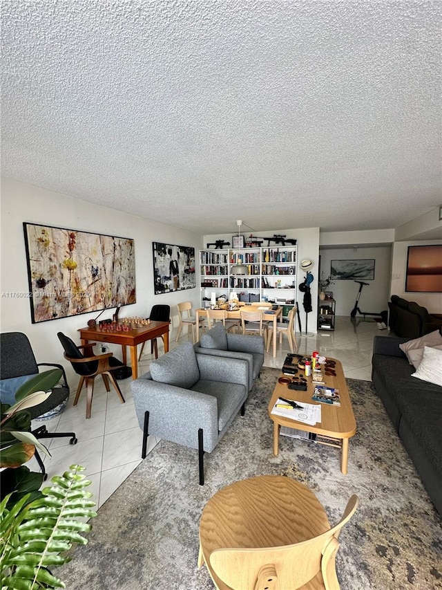 tiled living room featuring a textured ceiling