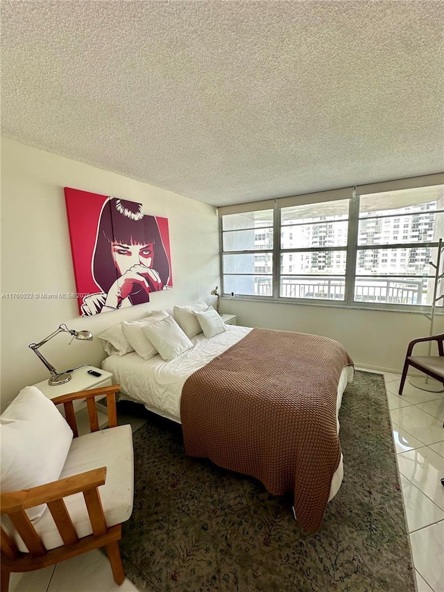 tiled bedroom with a textured ceiling