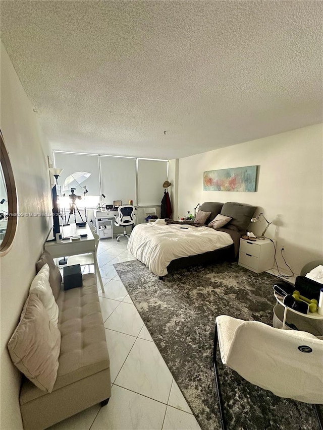 bedroom featuring light tile patterned floors and a textured ceiling