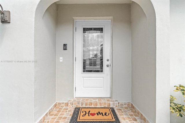 entrance to property with stucco siding