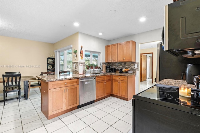 kitchen featuring stainless steel dishwasher, a peninsula, electric range, and stone counters