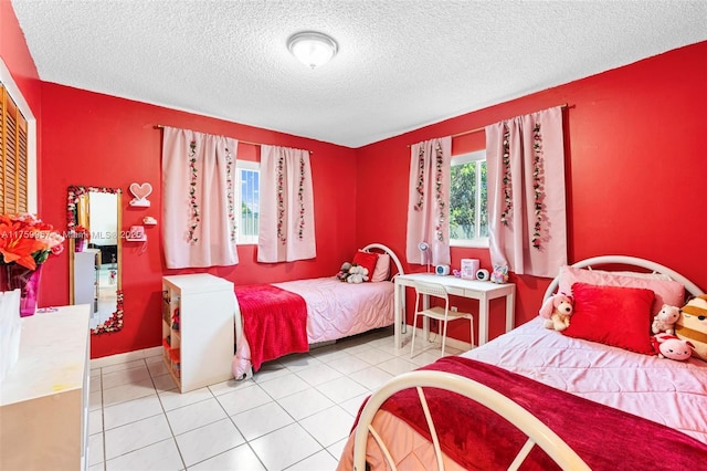 bedroom with tile patterned flooring and a textured ceiling