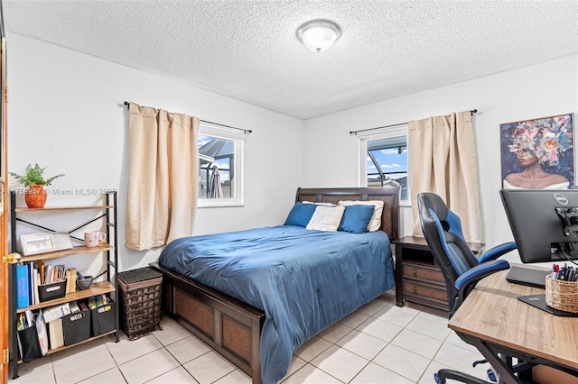 bedroom with tile patterned floors and a textured ceiling