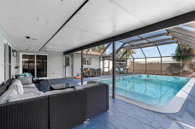 view of pool with a lanai, an outdoor living space, a patio, and a fenced in pool