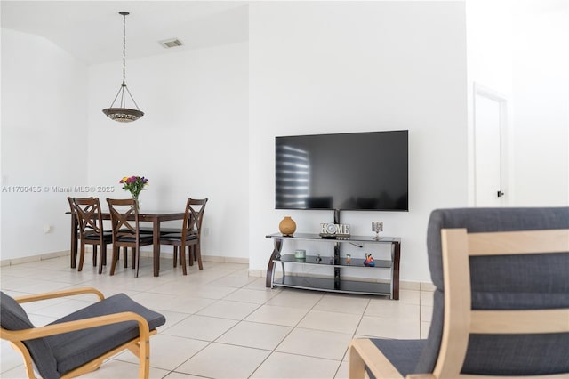 living room with light tile patterned floors, baseboards, and visible vents