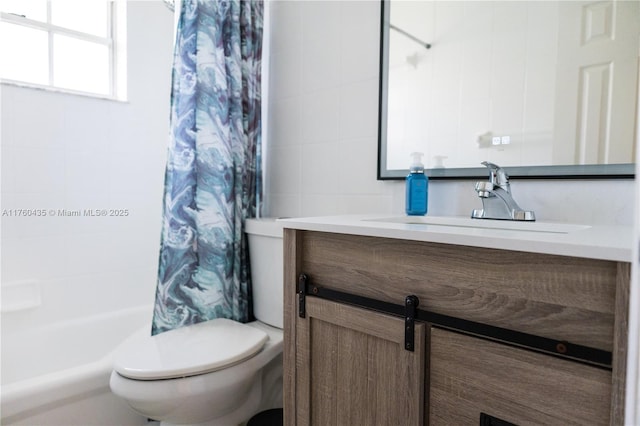 bathroom featuring vanity, tile walls, and toilet