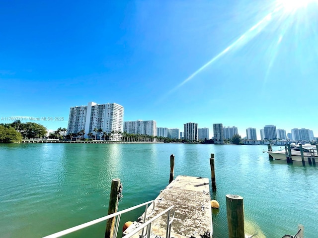 view of dock featuring a view of city and a water view