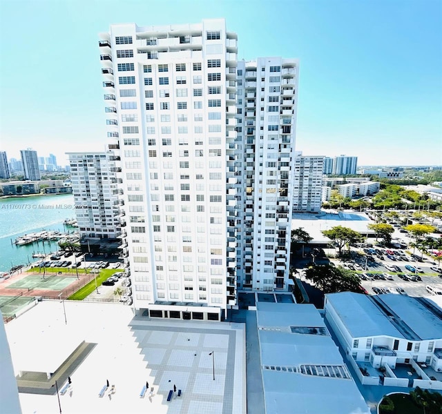 view of building exterior featuring a view of city and a water view