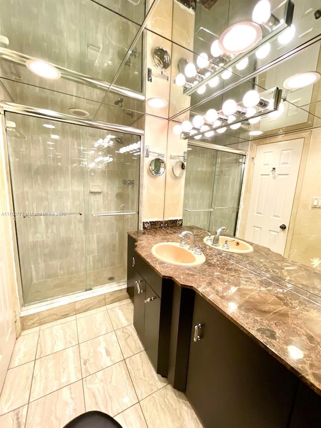 full bathroom featuring a stall shower and vanity