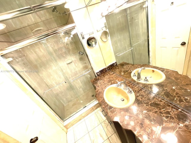 full bathroom with vanity, a shower stall, and tile patterned floors