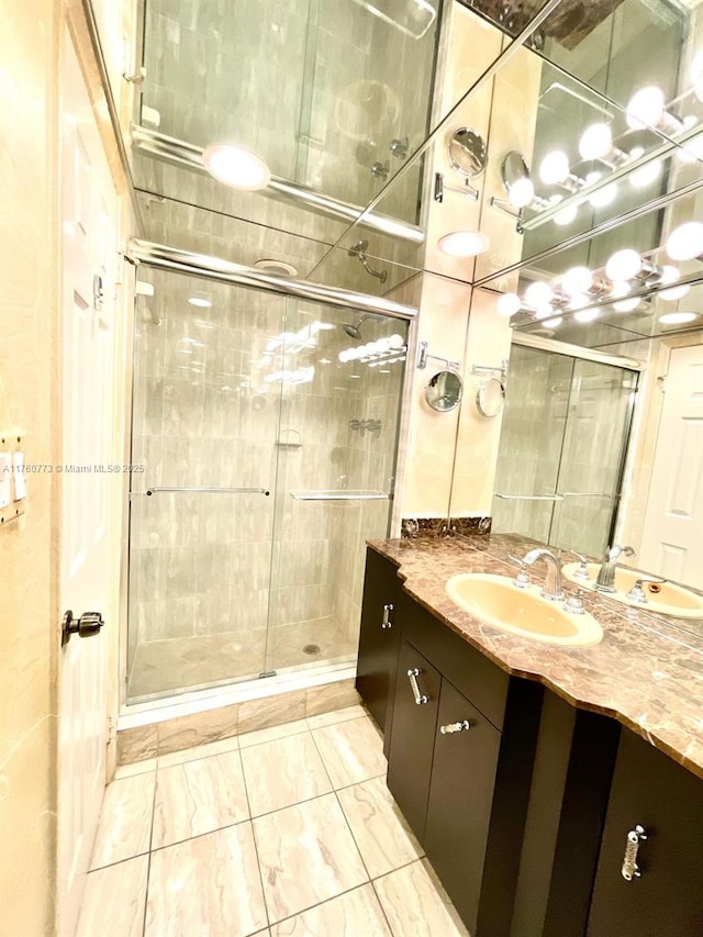 bathroom with vanity, marble finish floor, and a shower stall