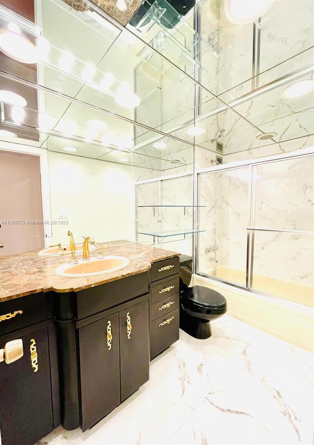 full bathroom with vanity, toilet, marble finish floor, and enclosed tub / shower combo