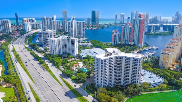 birds eye view of property featuring a view of city and a water view