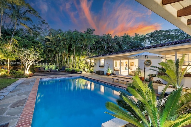 pool featuring a patio area and central AC unit