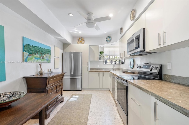 kitchen with white cabinetry, ceiling fan, recessed lighting, appliances with stainless steel finishes, and light speckled floor