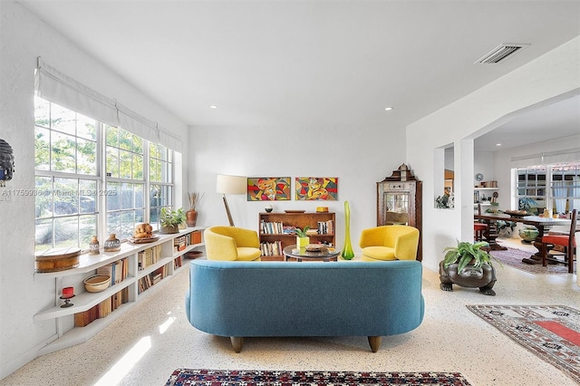 interior space featuring visible vents, recessed lighting, and speckled floor