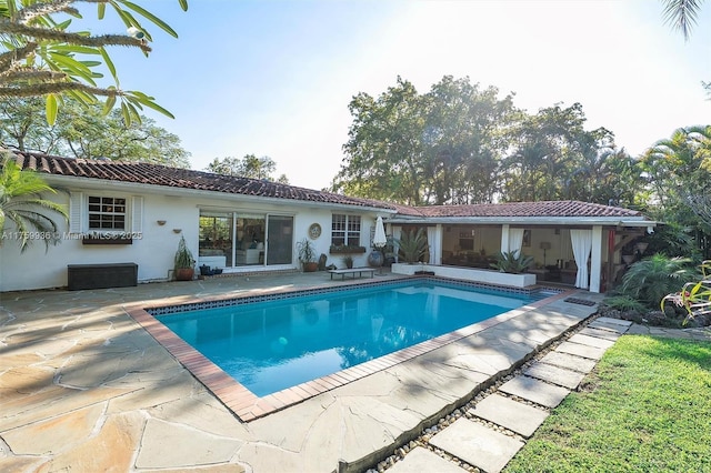 outdoor pool with a patio area