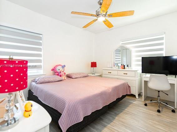 bedroom featuring a ceiling fan and light wood finished floors