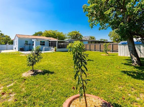 view of yard with an outdoor structure and a fenced backyard