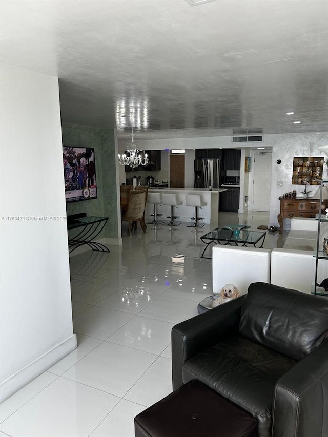 living area featuring an inviting chandelier and tile patterned floors