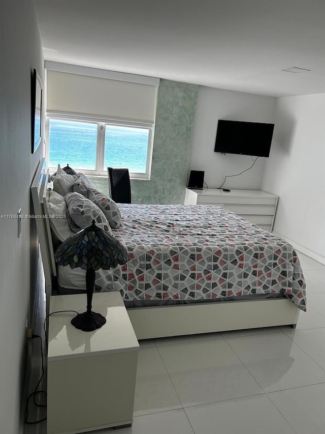 bedroom with light tile patterned floors